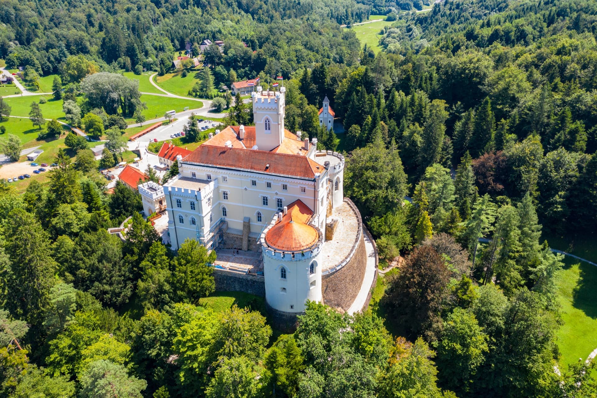 Trakošćan Castle rising above its lake surrounded by forests