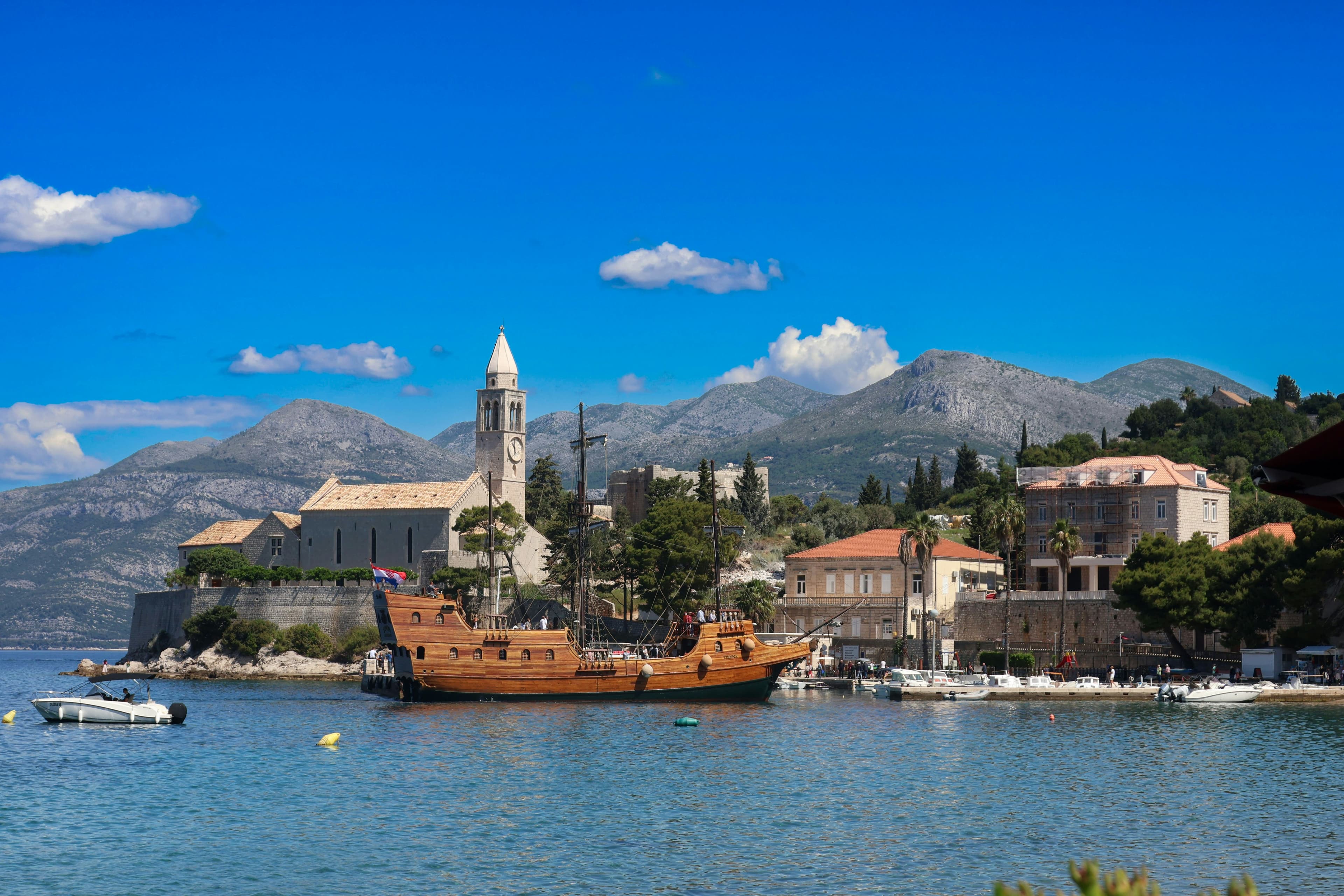 Lopud island — palm-lined waterfront promenade with turquoise Adriatic waters