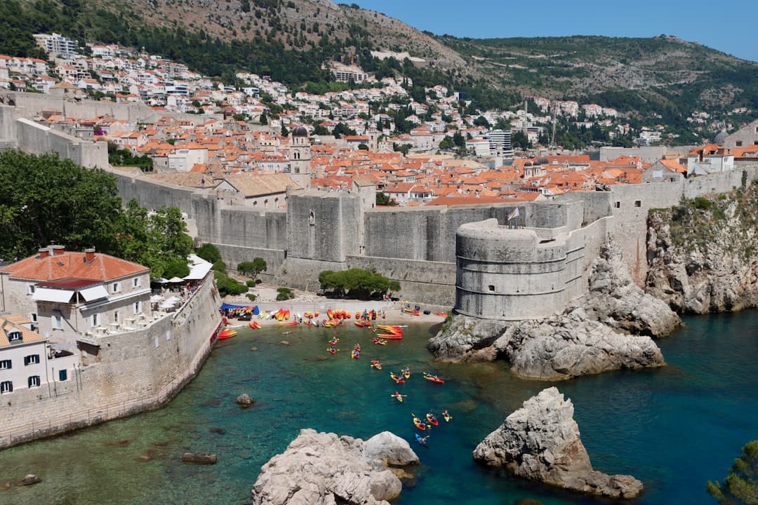 Wide view of Dubrovnik's Old Town walls and red-tiled roofs above the Adriatic, the launching point for the city's most photographed kayak route.