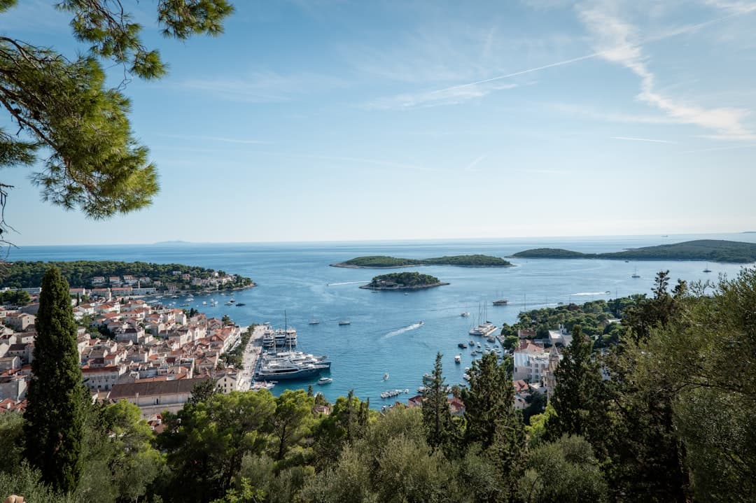 Hvar Town harbour with the Pakleni Islands strung out across the channel — the launch point for half-day and multi-day kayaking trips.