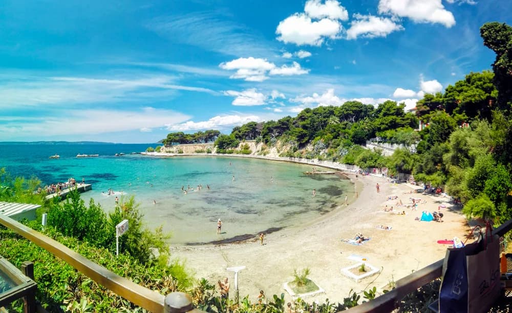 Firule Beach in Split with calm water and families swimming
