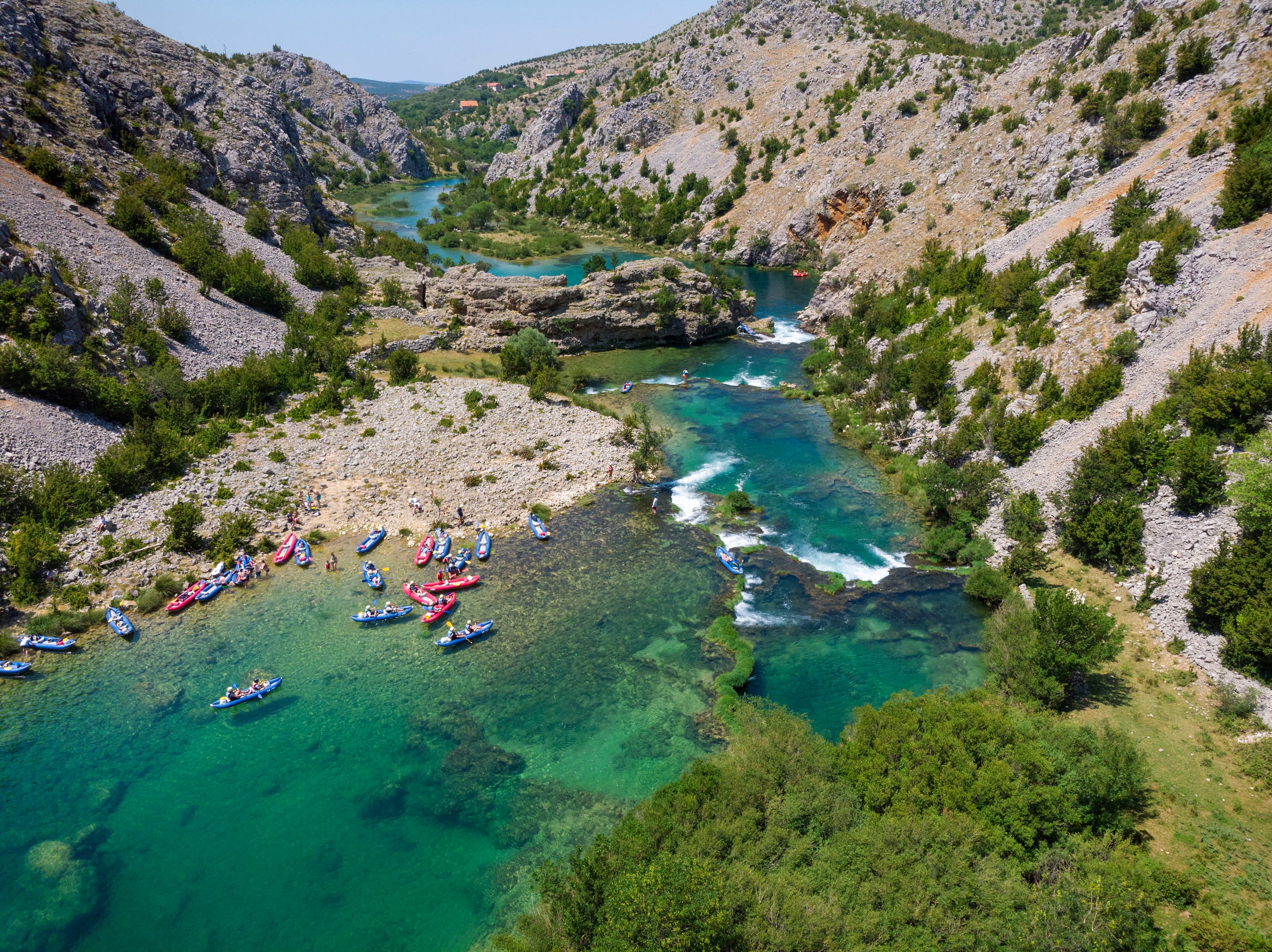 Crystal-clear emerald waters of Zrmanja River flowing through Velebit mountain range